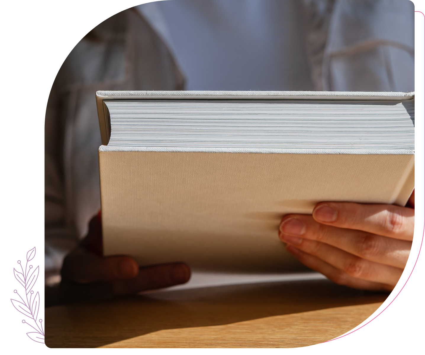 Person holding a closed book, reading posture.